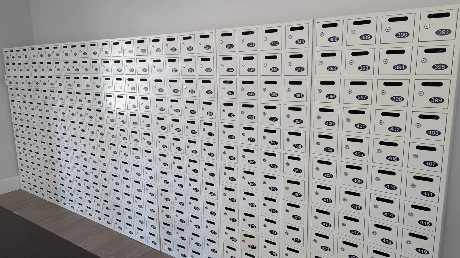 Wall of numbered private mailbox doors at Mailbox Plus in Concord Township, each with its own lock and mail slot