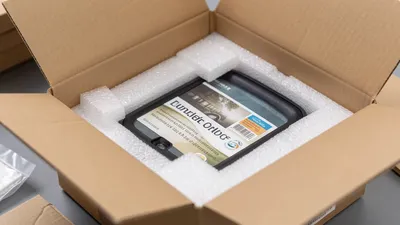 A box on a counter with a shipping label and an insurance declaration sticker