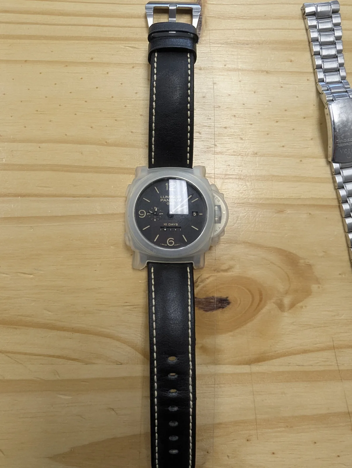 A high-value wristwatch being prepared for secure shipment on the packing counter at Mailbox Plus in Concord Township, OH.